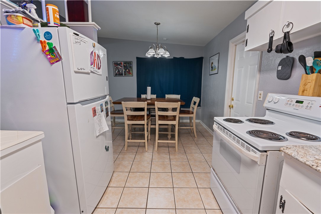 4846 Kasper Street Corpus Christi, TX 78415 - Photo 7 of 20 a kitchen with a stove and a refrigerator