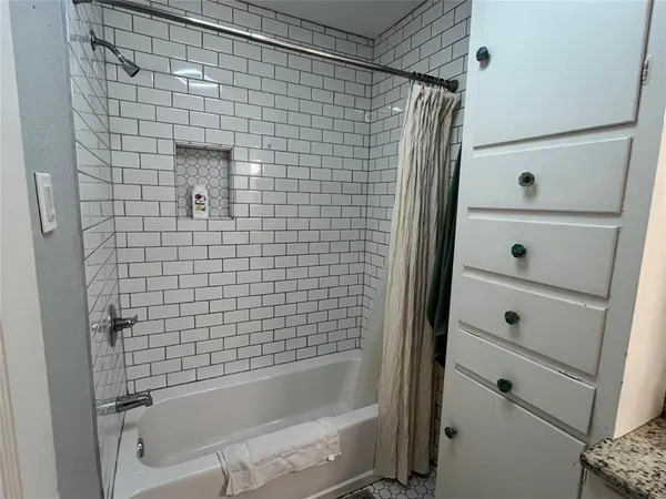 a bathroom with a granite countertop toilet sink and mirror