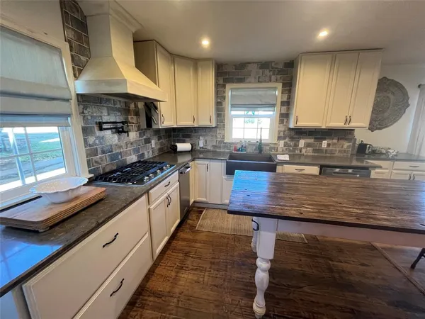 a kitchen with a refrigerator stove and cabinets