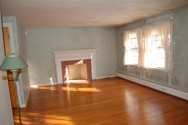 1 Cedarview Road Ipswich, MA 01938 - Photo 4 of 13 a view of an empty room with window and a kitchen