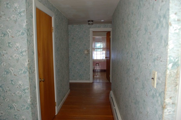 1 Cedarview Road Ipswich, MA 01938 - Photo 5 of 13 a view of a hallway with wooden floor and a bathroom