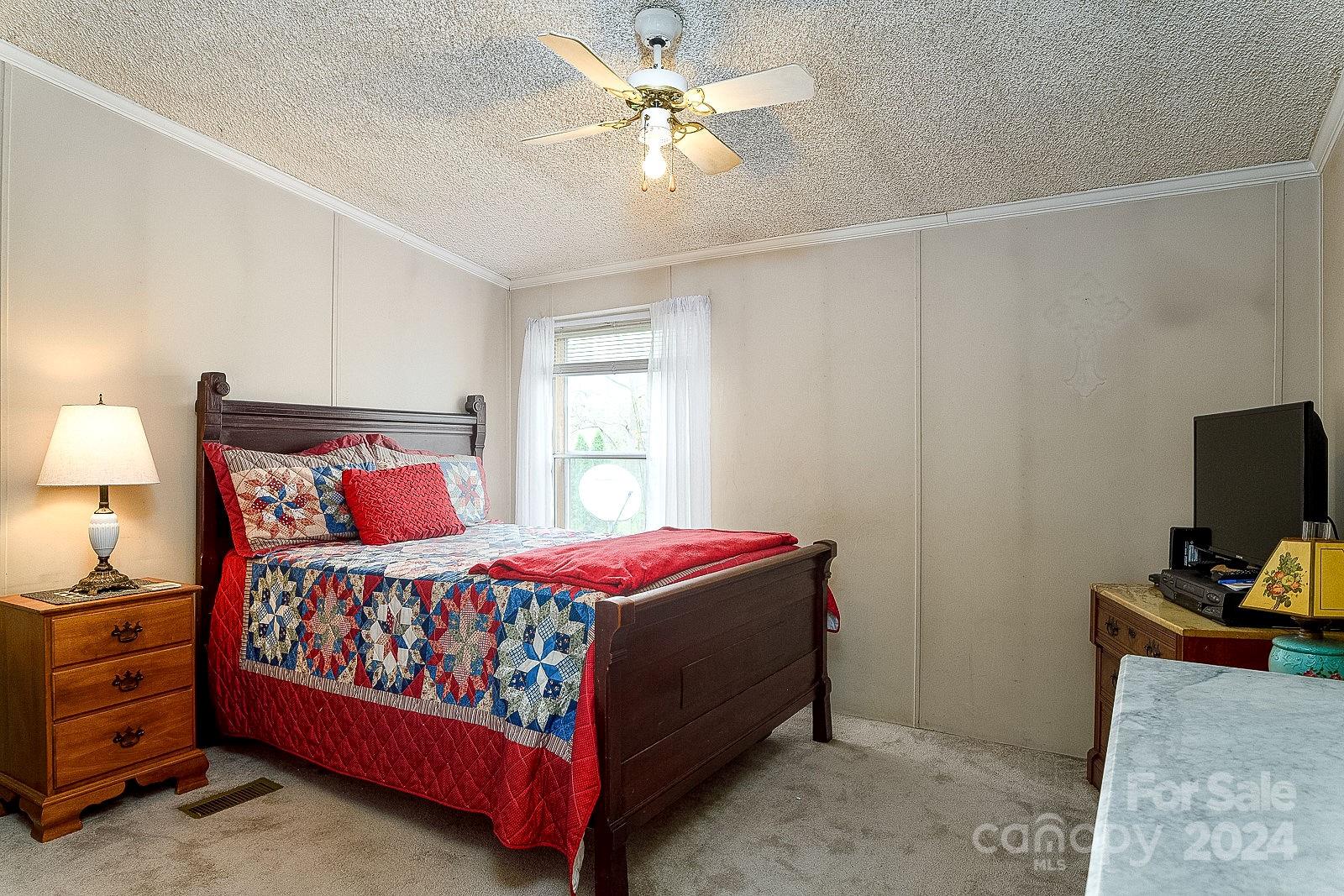 740 Childers Road Cleveland, NC 27013 - Photo 11 of 24 a bedroom with a bed and a tv in it