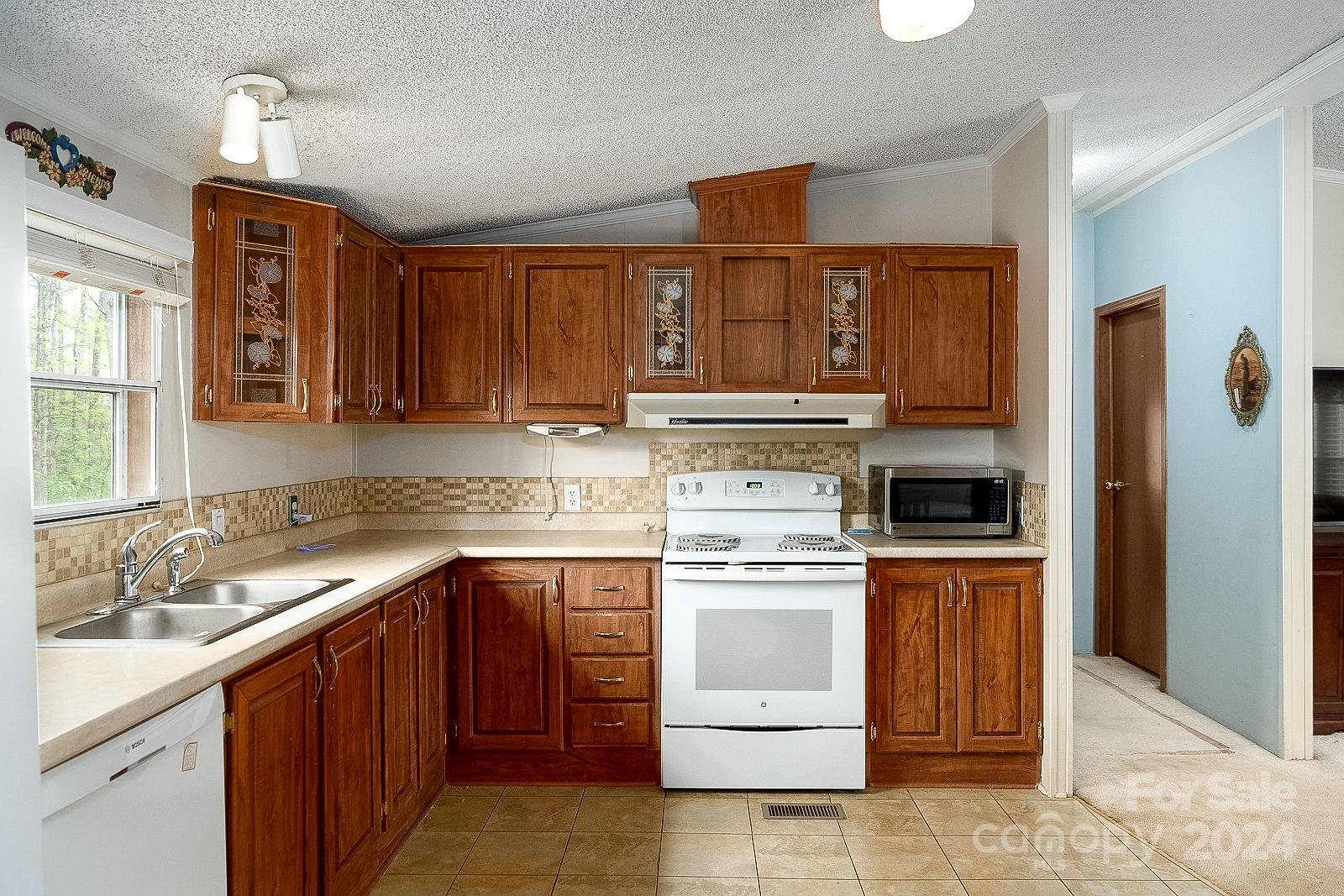 740 Childers Road Cleveland, NC 27013 - Photo 2 of 24 a kitchen with a stove sink and cabinets