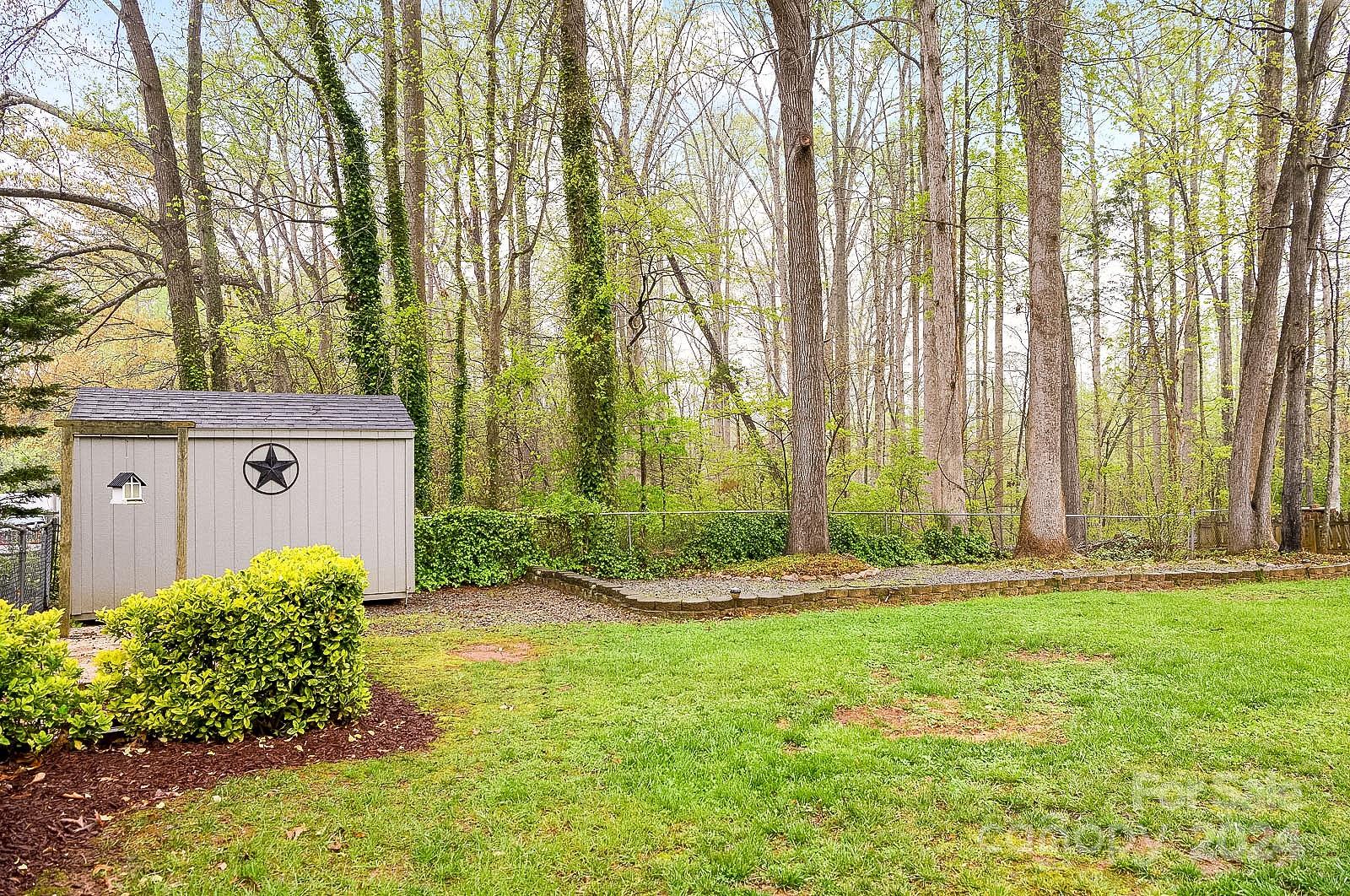740 Childers Road Cleveland, NC 27013 - Photo 23 of 24 a backyard of a house with lots of green space and fountain