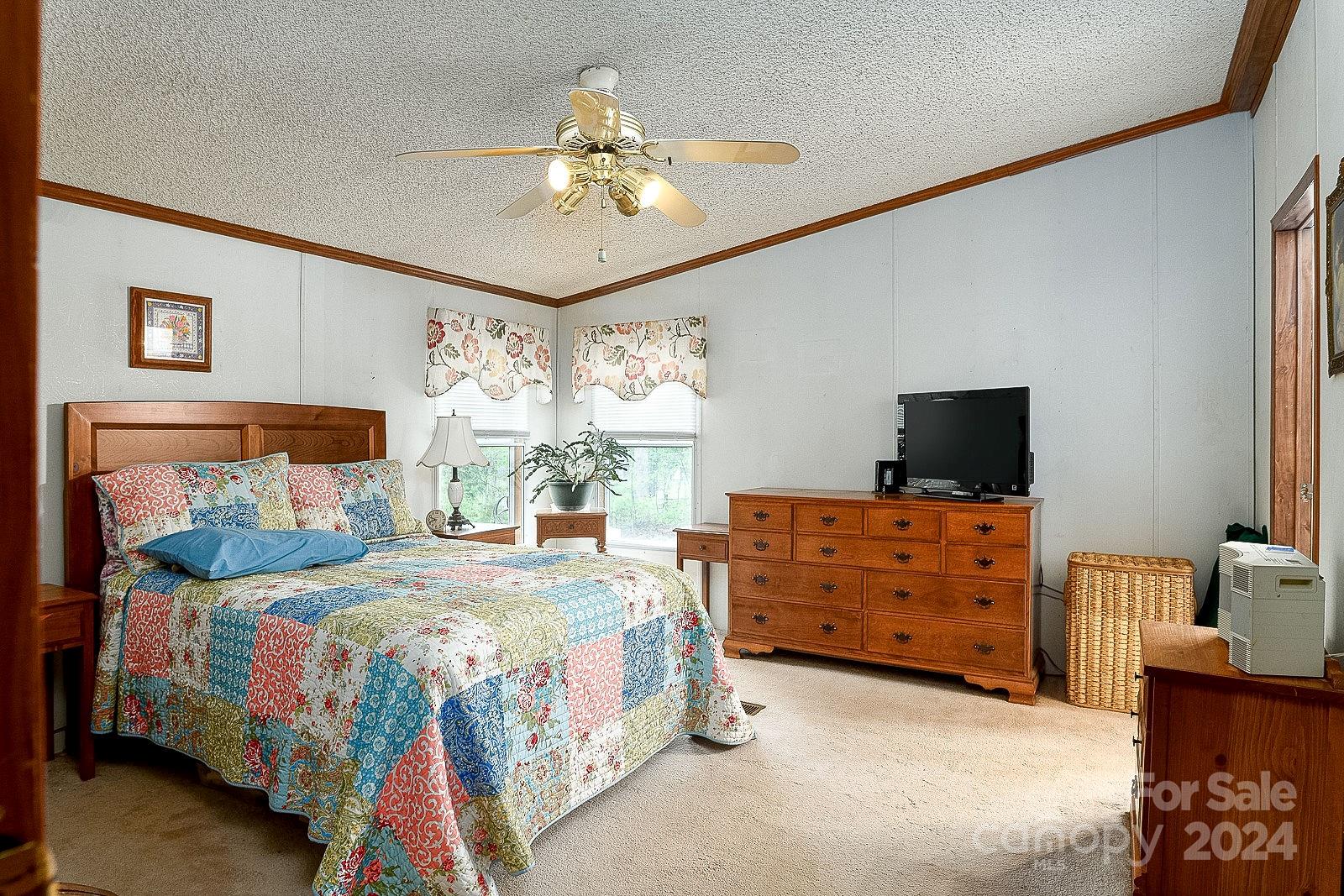 740 Childers Road Cleveland, NC 27013 - Photo 3 of 24 a bedroom with a bed and a chandelier