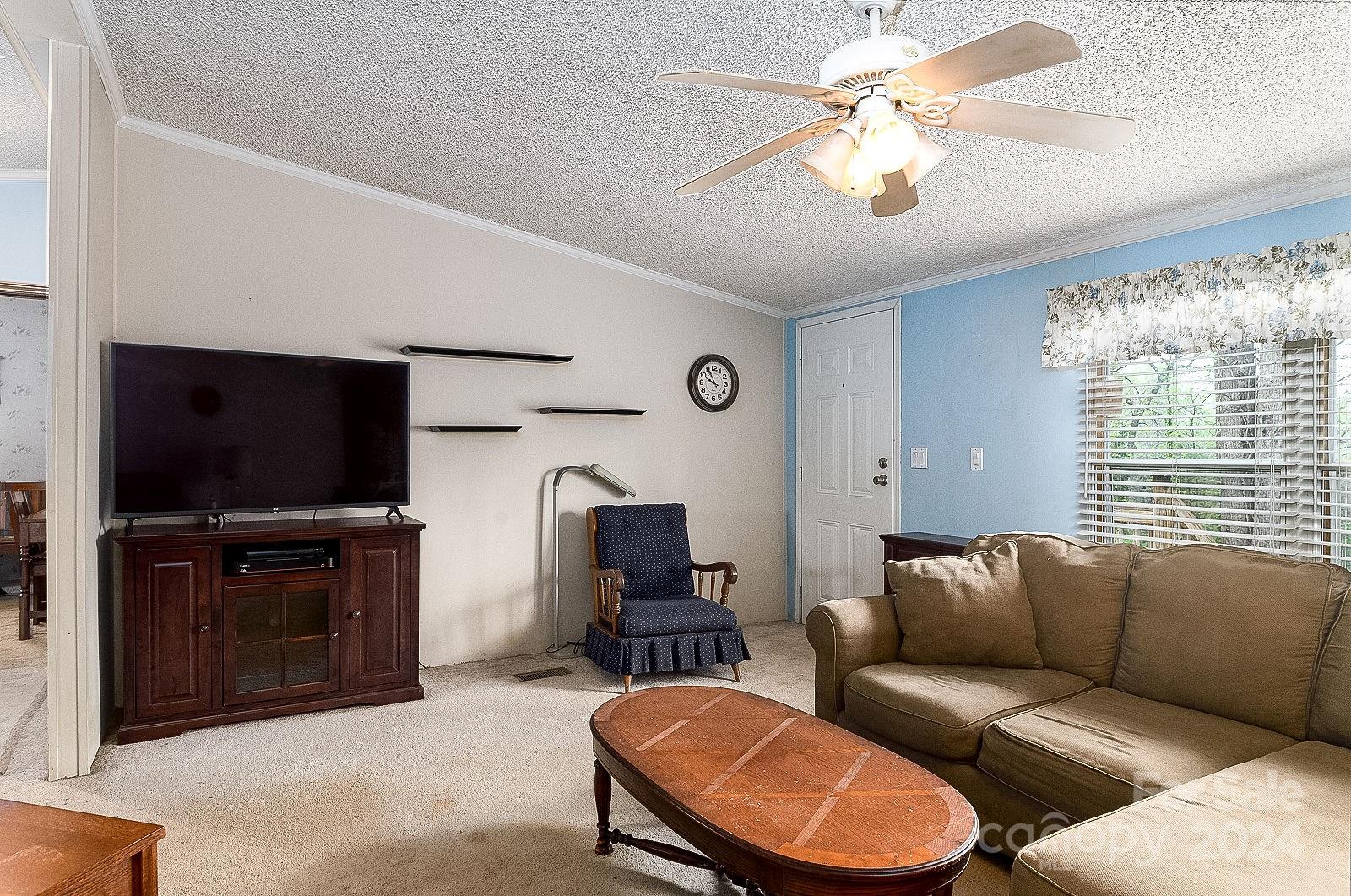 740 Childers Road Cleveland, NC 27013 - Photo 8 of 24 a living room with furniture a flat screen tv and kitchen view