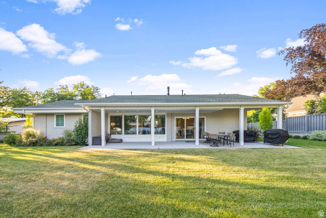 1774 Country Club Drive Logan, UT 84321 - Photo 26 of 28 Expansive rear exterior featuring a covered patio, multiple large windows, and a sliding glass door