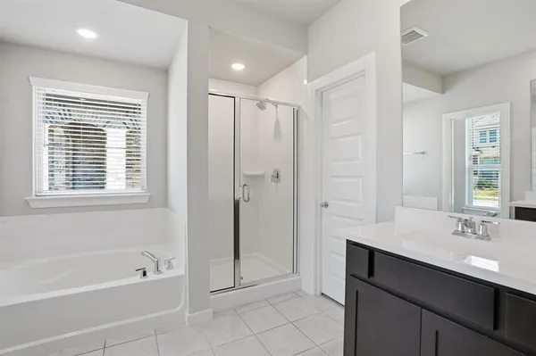 a bathroom with a tub sink and a mirror