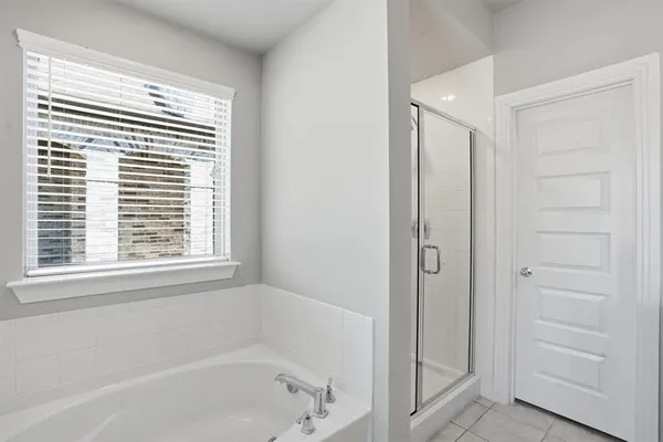 a bathroom with a bathtub and a shower