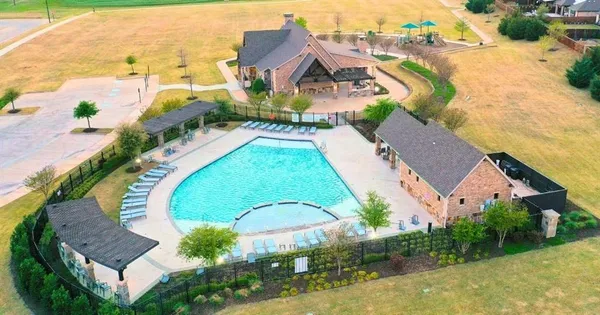 an aerial view of residential houses with outdoor space and swimming pool