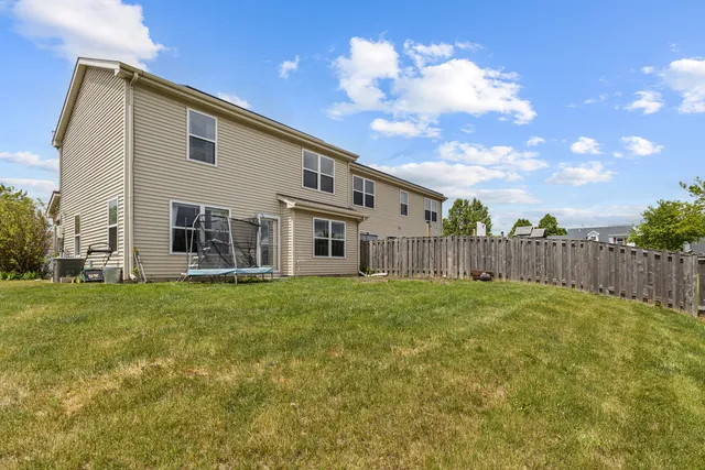 a view of a house with backyard and porch