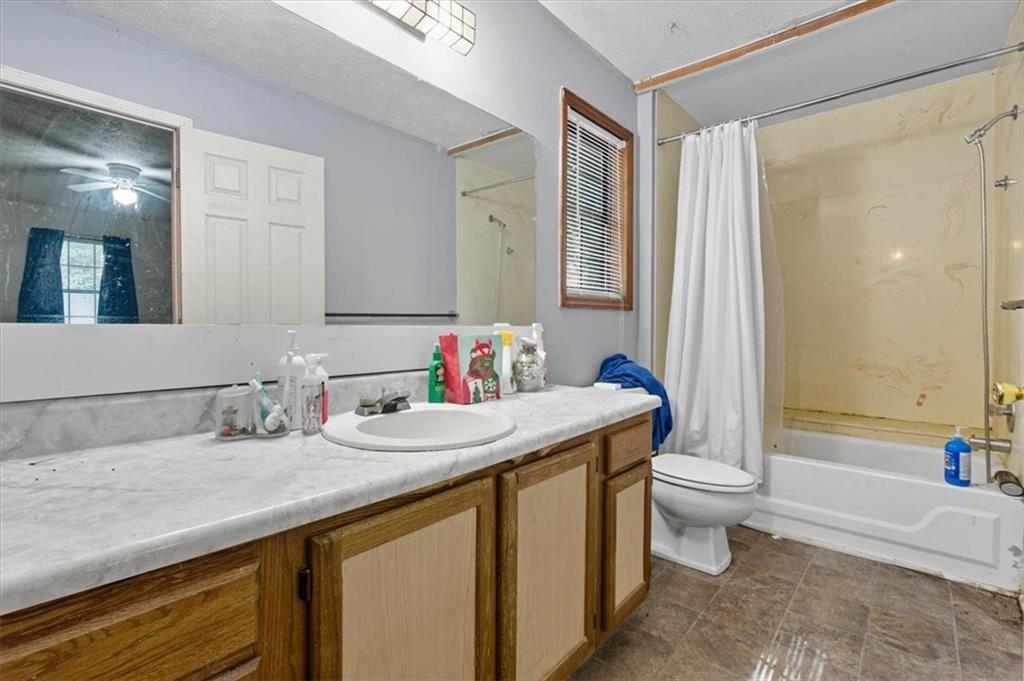 31 Powder Mill Drive Dallas, GA 30157 - Photo 11 of 41 a bathroom with a granite countertop sink mirror vanity bathtub and a toilet