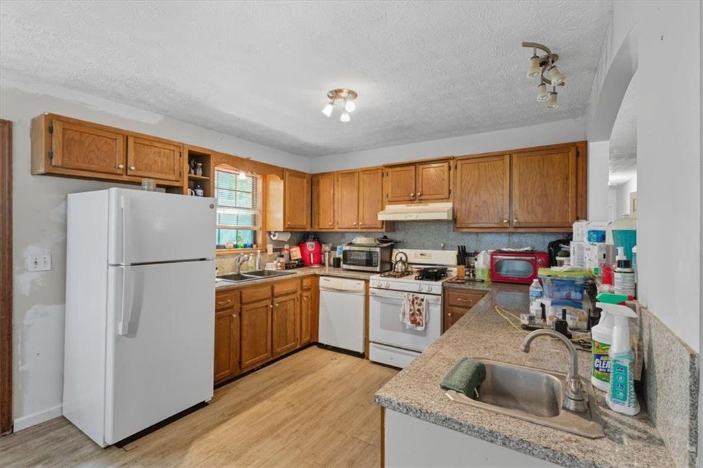 31 Powder Mill Drive Dallas, GA 30157 - Photo 17 of 41 a kitchen with a refrigerator sink and cabinets