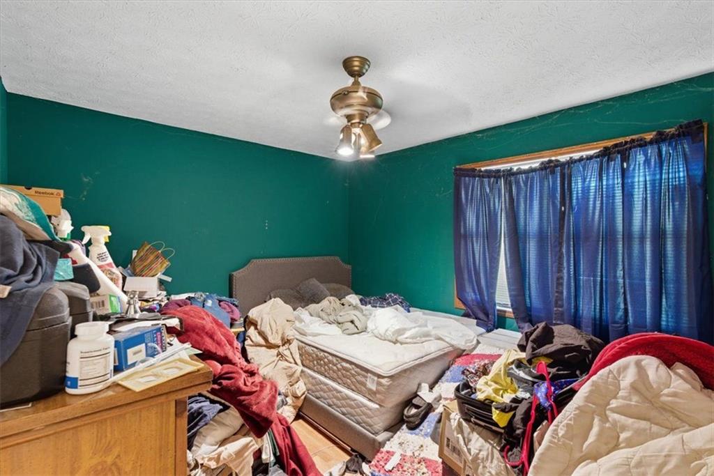 31 Powder Mill Drive Dallas, GA 30157 - Photo 24 of 41 a bed room with a bed and a chandelier