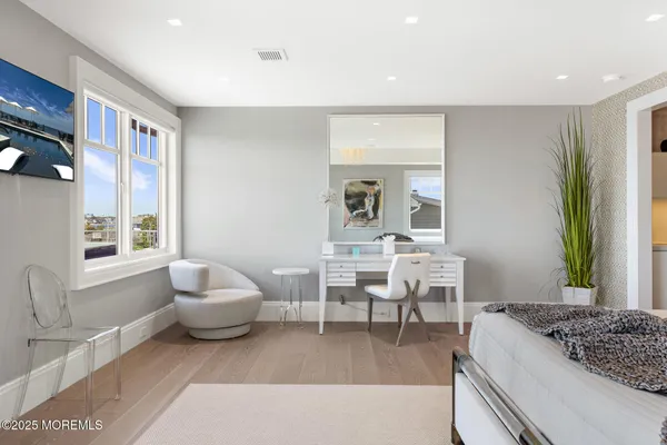 a spacious bedroom with a bed and a large window