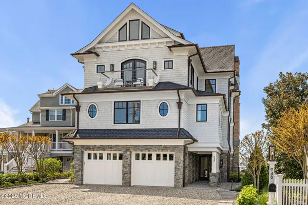 a kitchen with cabinets a sink dishwasher a dining table and chairs with wooden floor