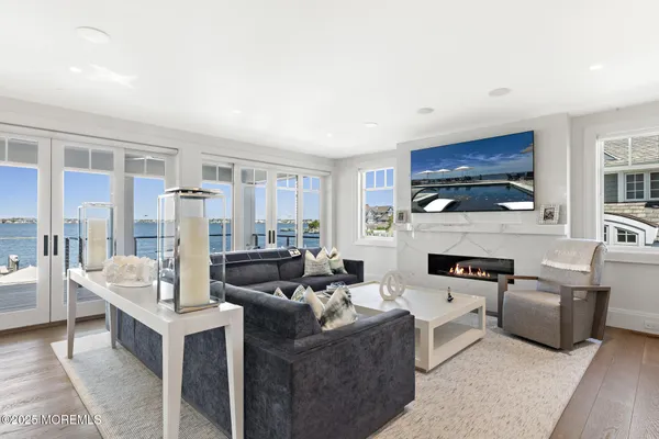 a living room with furniture a floor to ceiling window and an outdoor view