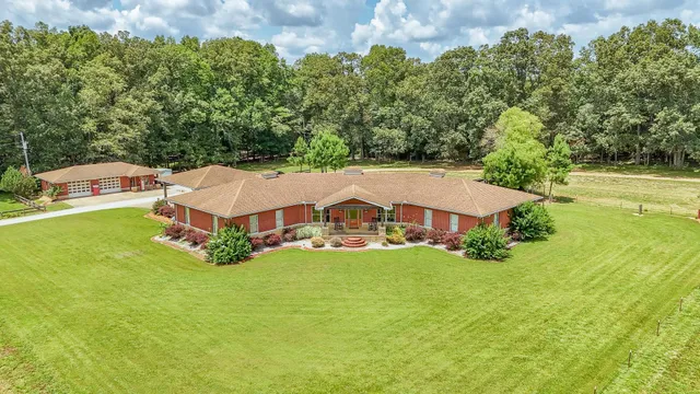 a aerial view of a house with swimming pool and garden