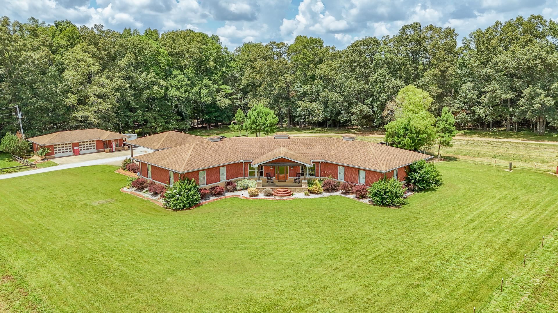 a aerial view of a house with swimming pool and garden