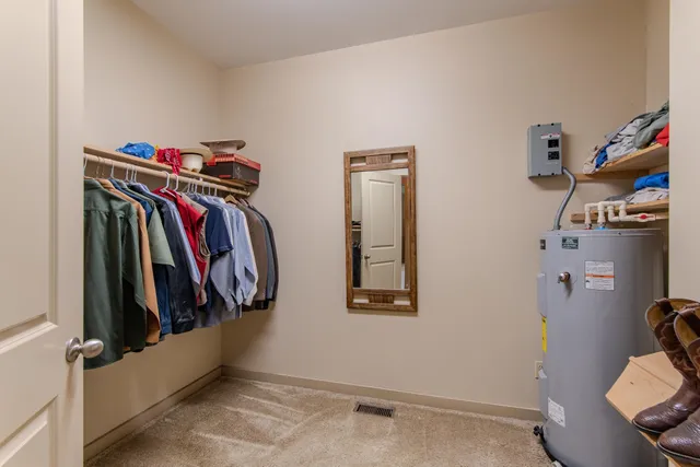 a spacious bathroom with a granite countertop sink and a mirror