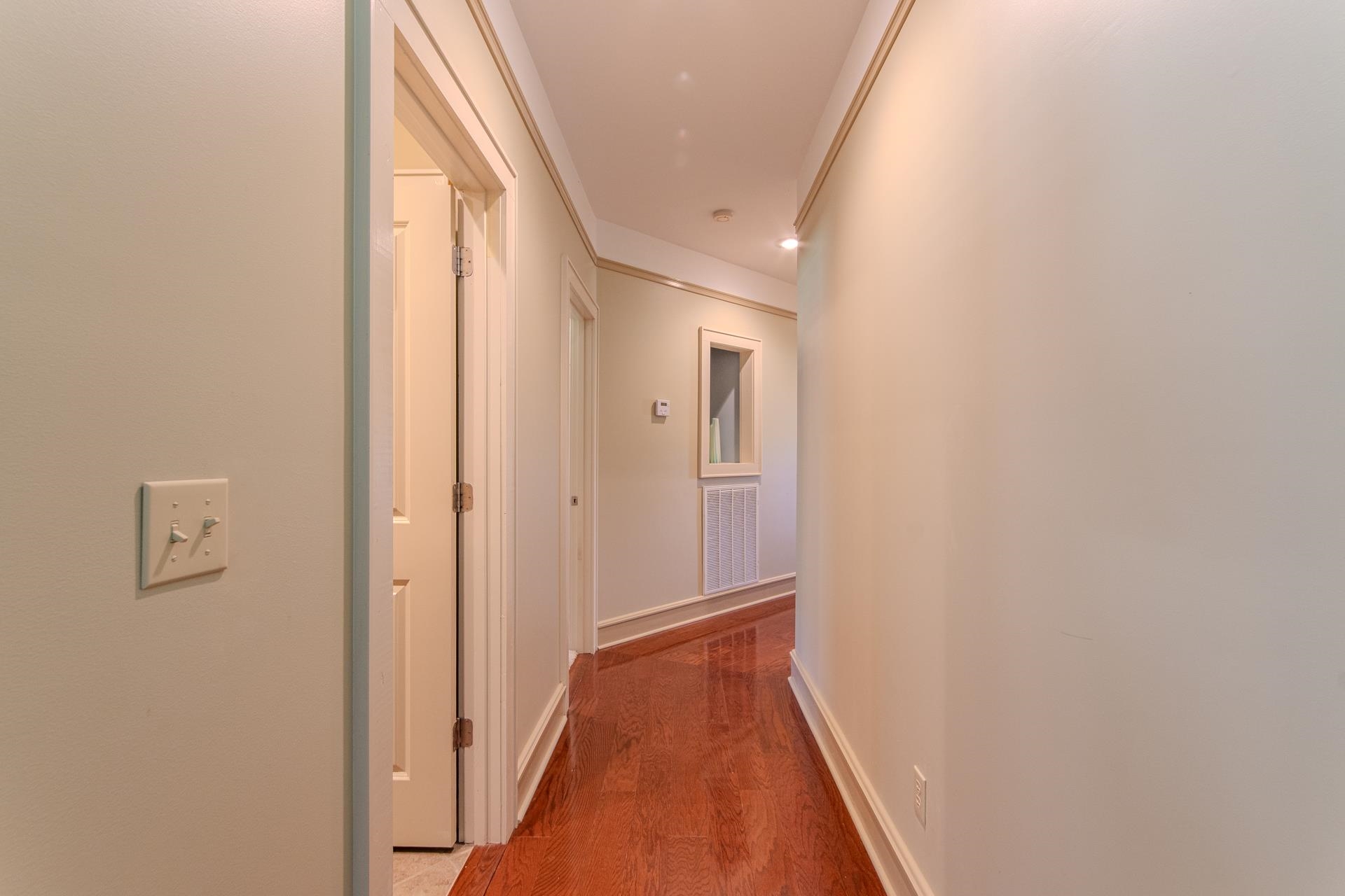 2690 Fellowship Road Sardis, TN 38371 - Photo 24 of 39 a view of a hallway with wooden floor and a bathroom
