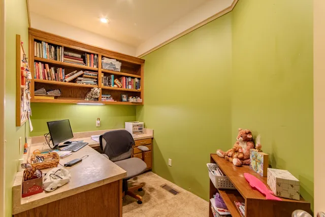 a work room with furniture and a large window