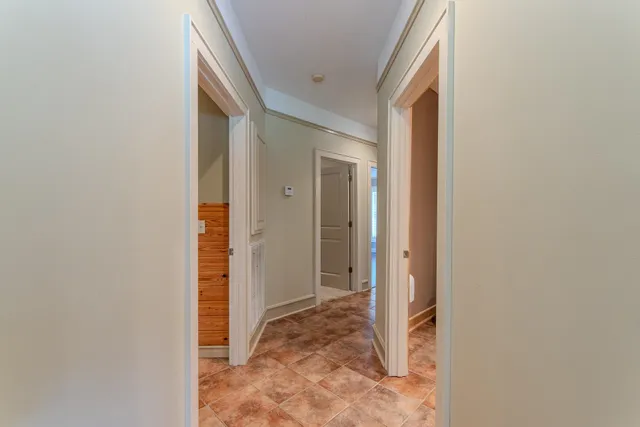 a view of a dining room and livingroom with furniture wooden floor a chandelier