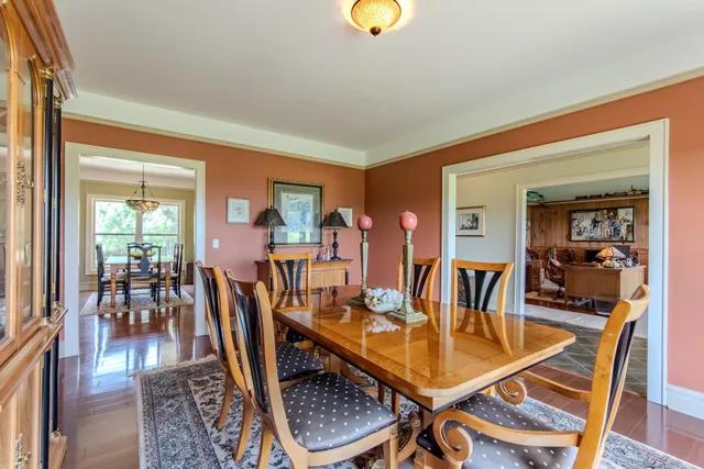 a dining room with furniture and wooden floor