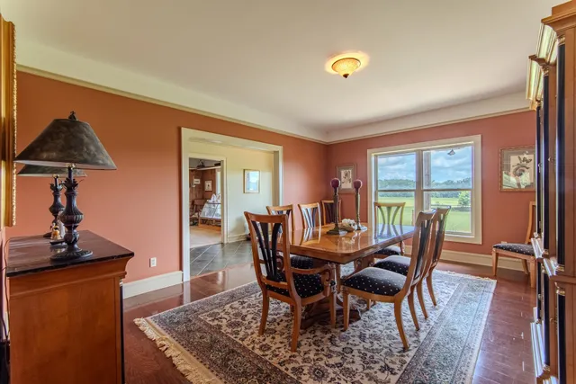 a living room with furniture a flat screen tv and a window