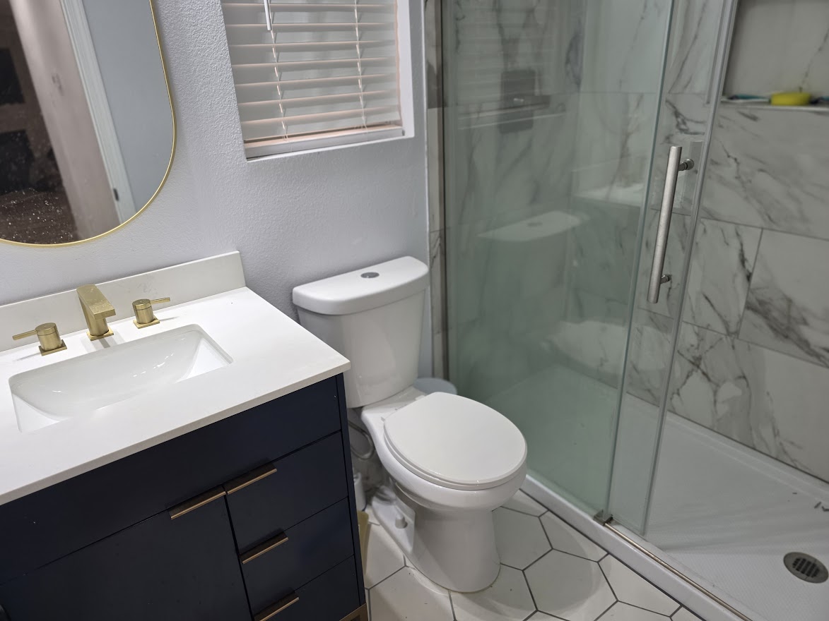 4803 Peach Grove Road Austin, TX 78744 - Photo 12 of 22 a bathroom with a sink toilet and shower