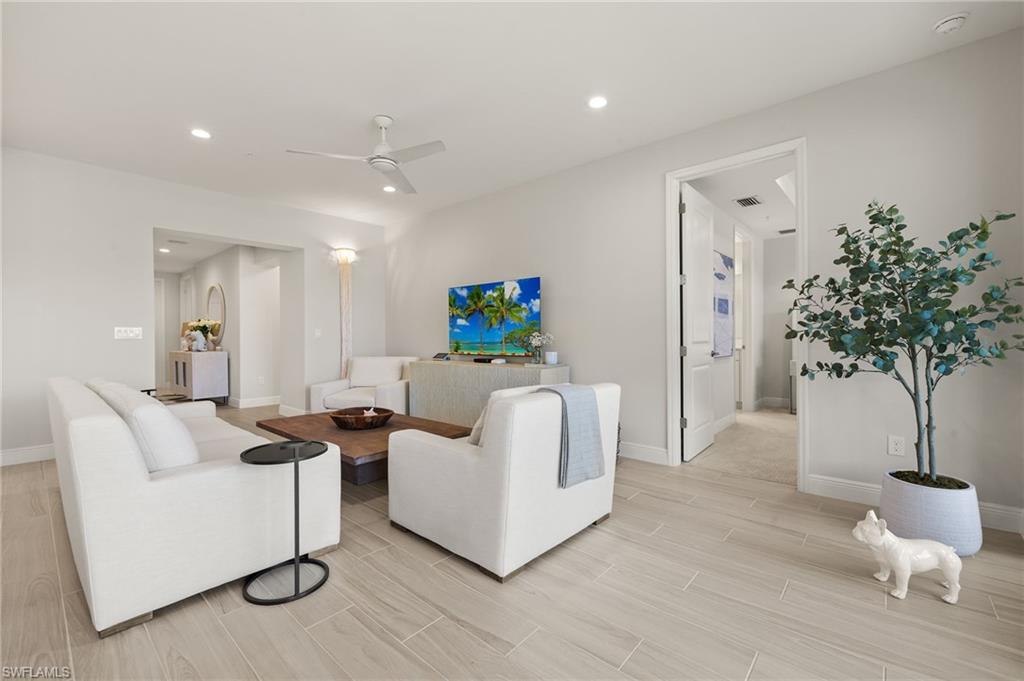 2647 Seychelles Circle, Unit 2203 Naples, FL 34112 - Photo 10 of 32 a living room with furniture and a potted plant