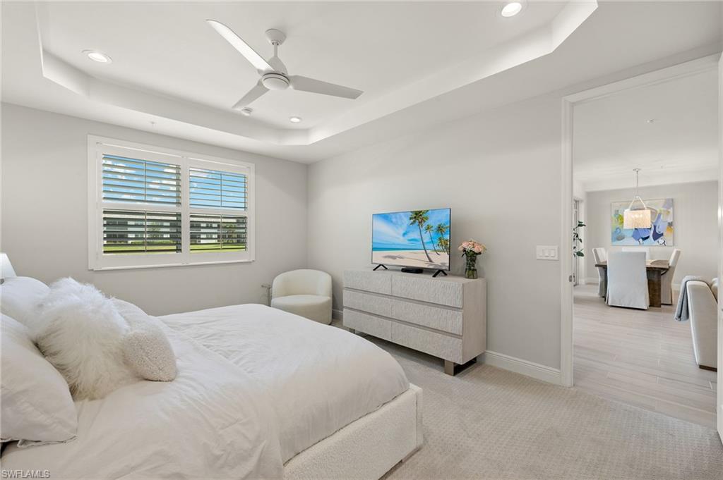 2647 Seychelles Circle, Unit 2203 Naples, FL 34112 - Photo 14 of 32 a bedroom with furniture and a large window