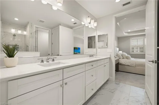 a bedroom with furniture and a large window