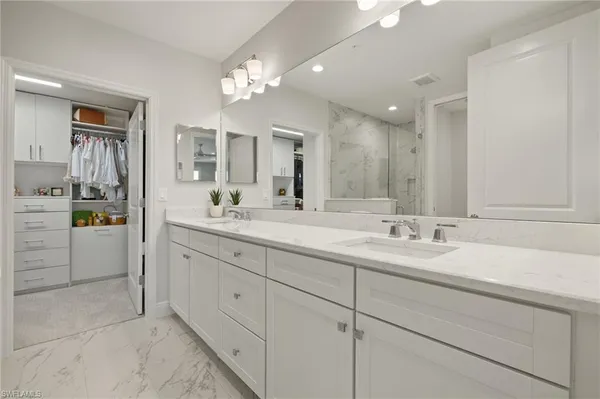 a bedroom with furniture and a chandelier