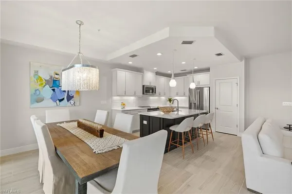 a large kitchen with a table and chairs
