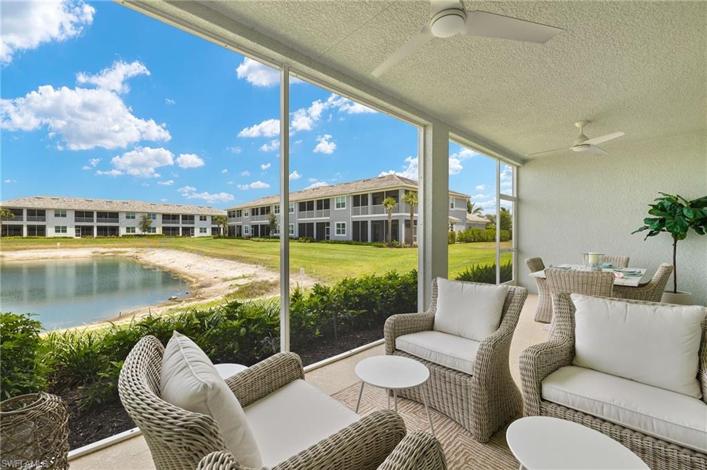 2647 Seychelles Circle, Unit 2203 Naples, FL 34112 - Photo 21 of 32 a view of a patio with couches chairs and a floor to ceiling window yard