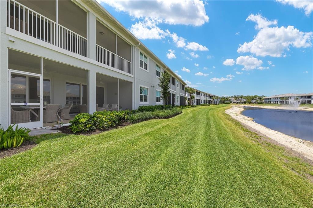 2647 Seychelles Circle, Unit 2203 Naples, FL 34112 - Photo 23 of 32 a view of an house with swimming pool and an outdoor seating