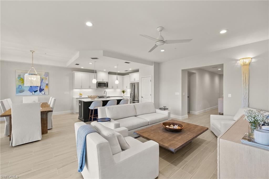 2647 Seychelles Circle, Unit 2203 Naples, FL 34112 - Photo 2 of 32 Living room featuring wood finish floors, ceiling fan, baseboards, and recessed lighting
