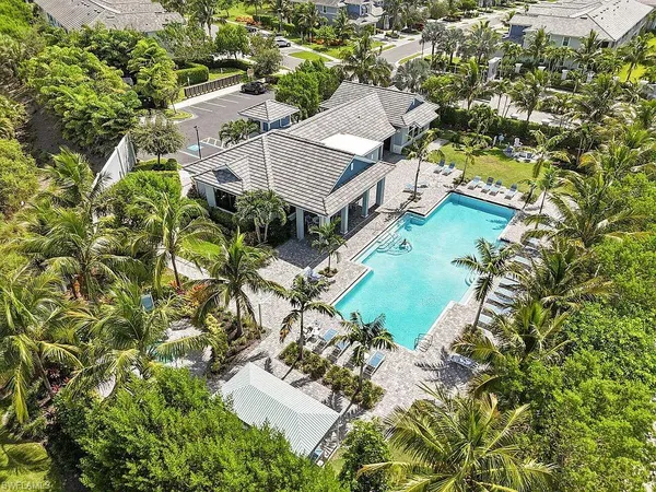 a front view of yellow house with a yard