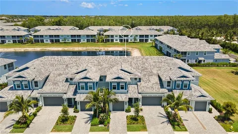 a front view of yellow house with a yard