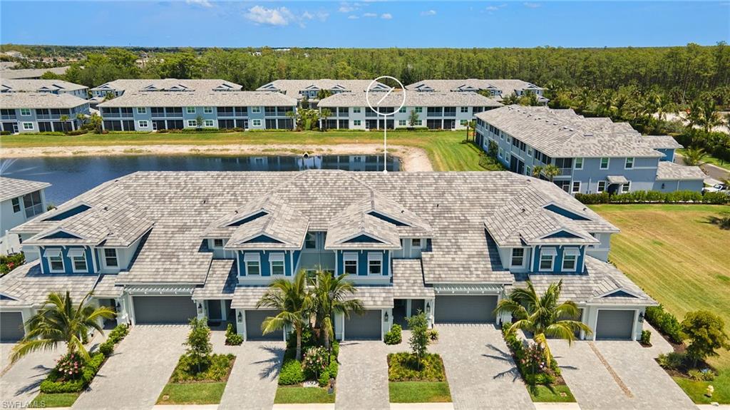 2647 Seychelles Circle, Unit 2203 Naples, FL 34112 - Photo 30 of 32 an aerial view of houses with swimming pool