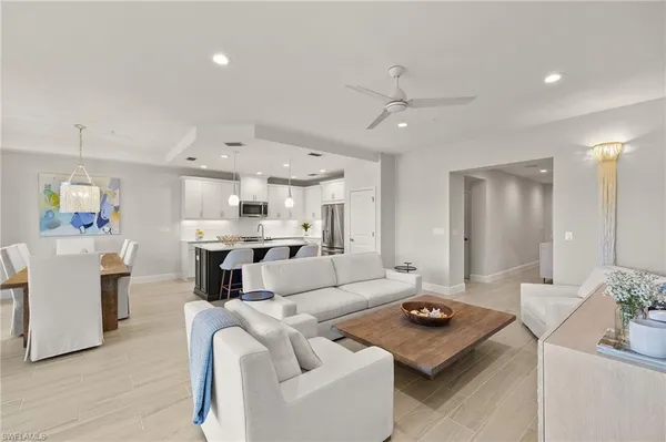 a kitchen with center island white cabinets and stainless steel appliances