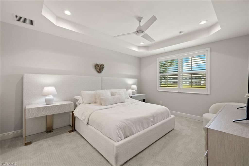 2647 Seychelles Circle, Unit 2203 Naples, FL 34112 - Photo 7 of 32 Bedroom featuring a raised ceiling, light carpet, baseboards, recessed lighting, and ceiling fan