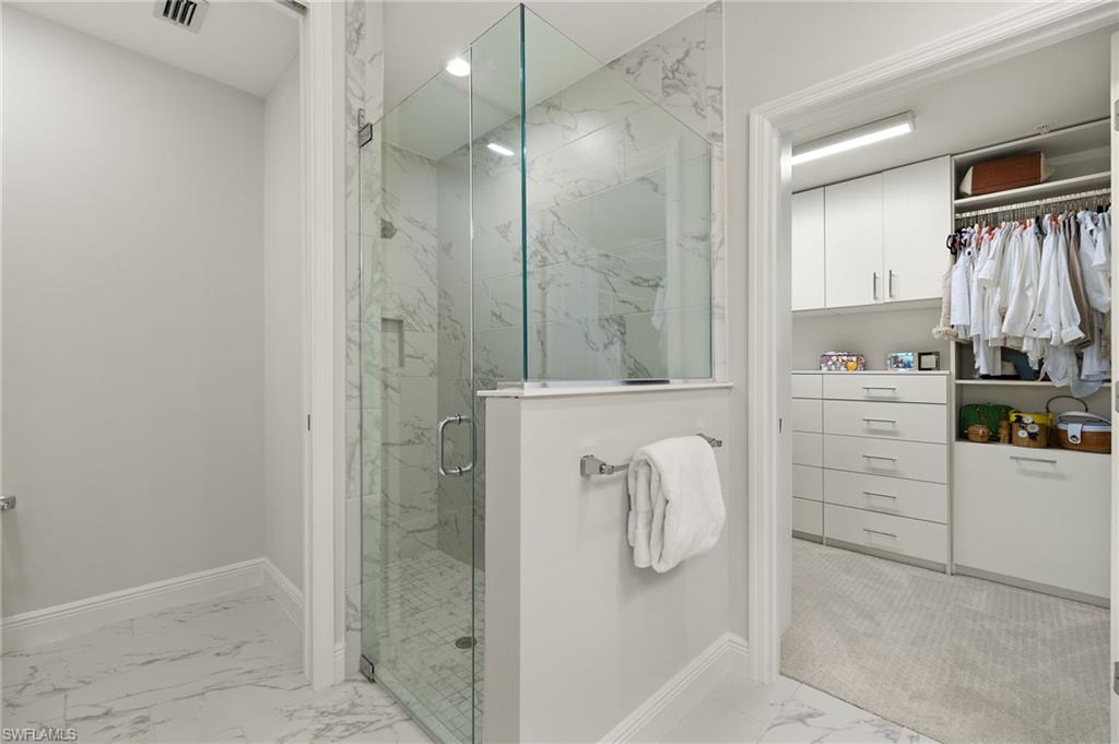 2647 Seychelles Circle, Unit 2203 Naples, FL 34112 - Photo 7 of 32 a bathroom with a bathtub and a shower