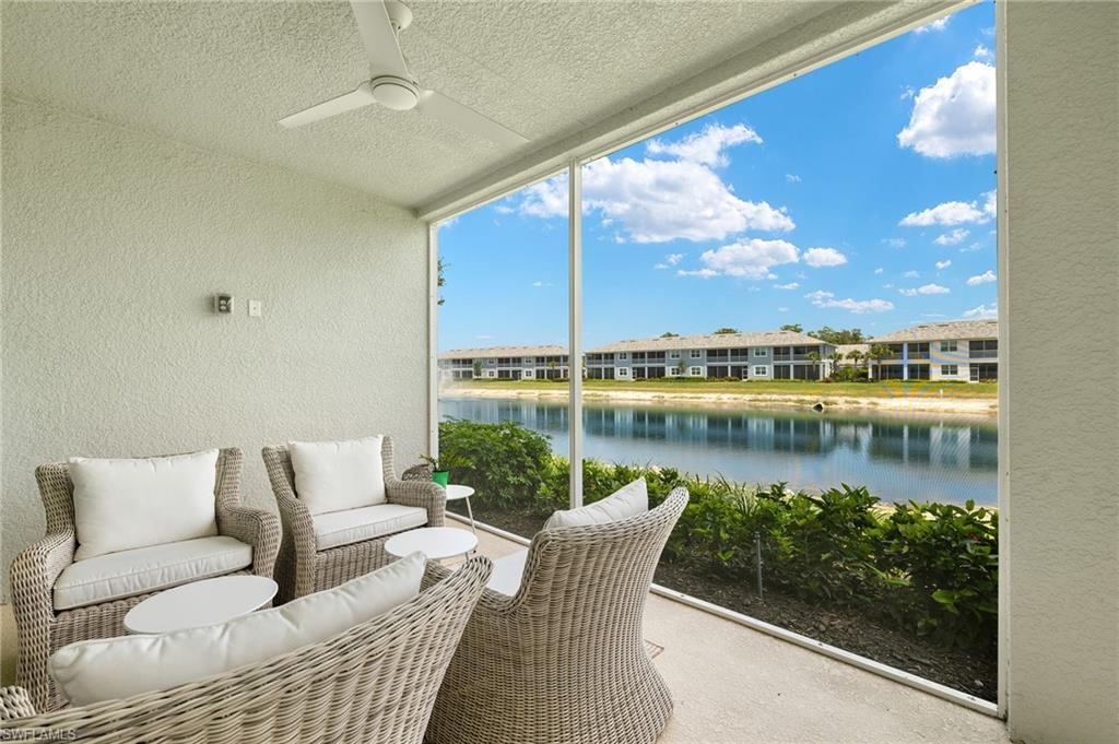 2647 Seychelles Circle, Unit 2203 Naples, FL 34112 - Photo 9 of 32 Sunroom featuring ceiling fan and a water view