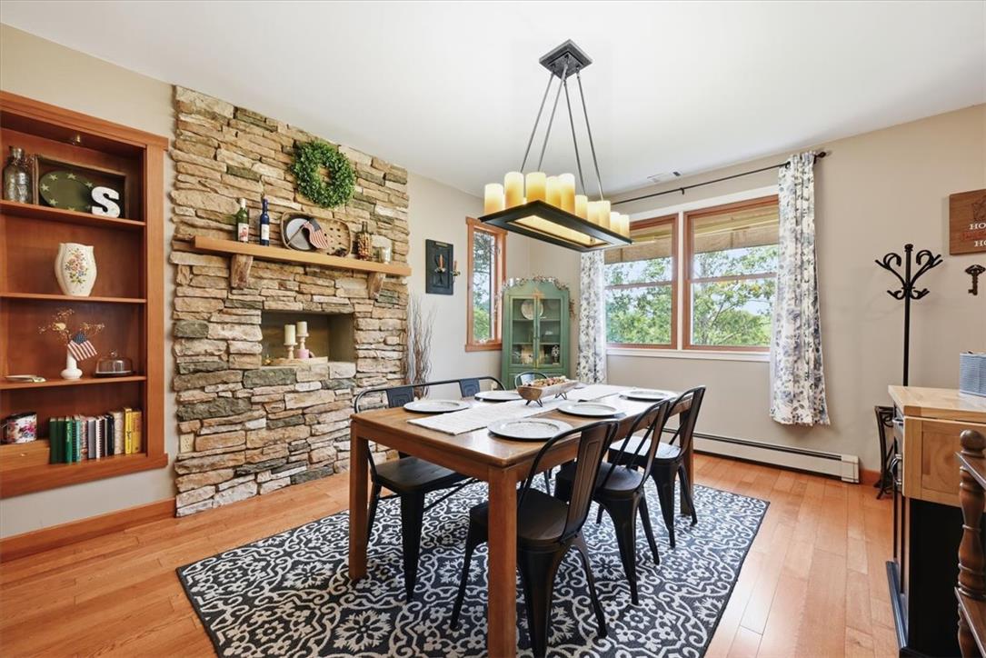 7722 Sechler Road New Tripoli, PA 18066 - Photo 17 of 58 Rich hardwood flooring complements a striking floor-to-ceiling stone fireplace in this classic dining space.