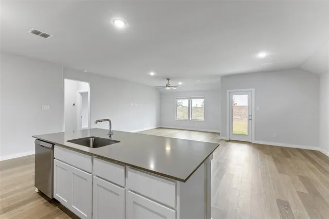 a kitchen with sink and mirror