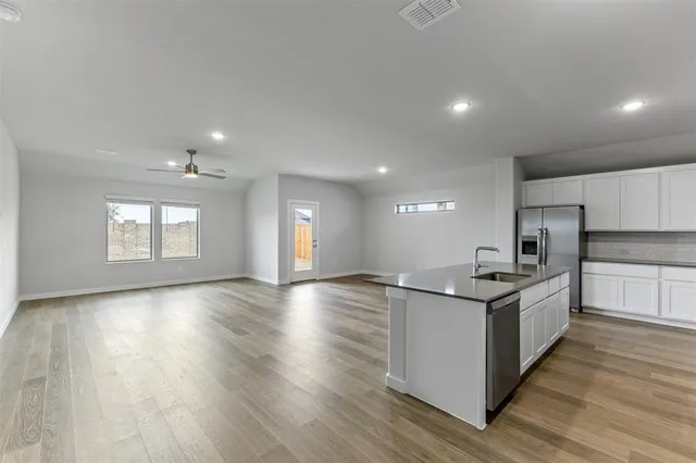 a kitchen with stainless steel appliances granite countertop a sink and stove top oven