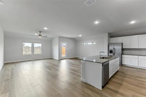 a kitchen with stainless steel appliances granite countertop a sink and stove top oven