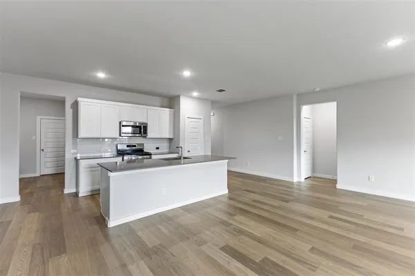 a view of kitchen with sink microwave and stove